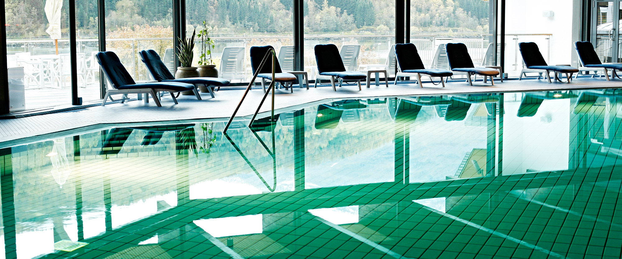 Hotel swimming pool Indoor pool with pool surround and recliners