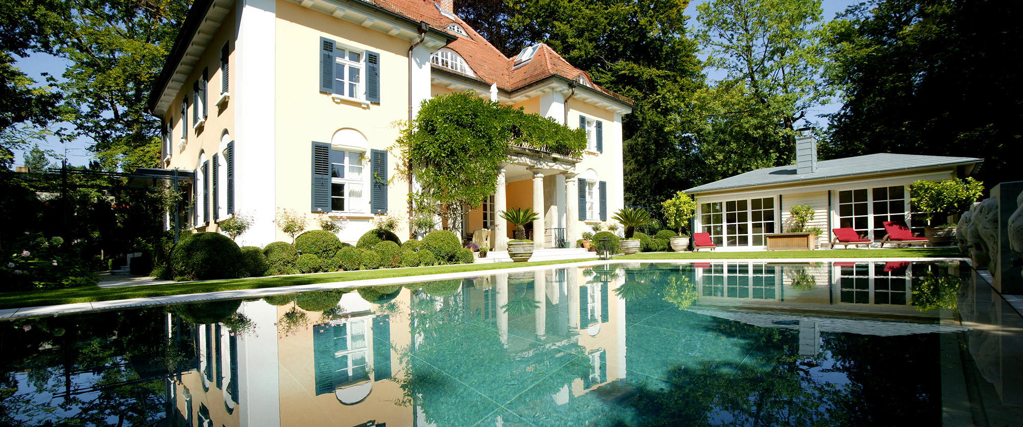 Grand outdoor pool with villa and back yard