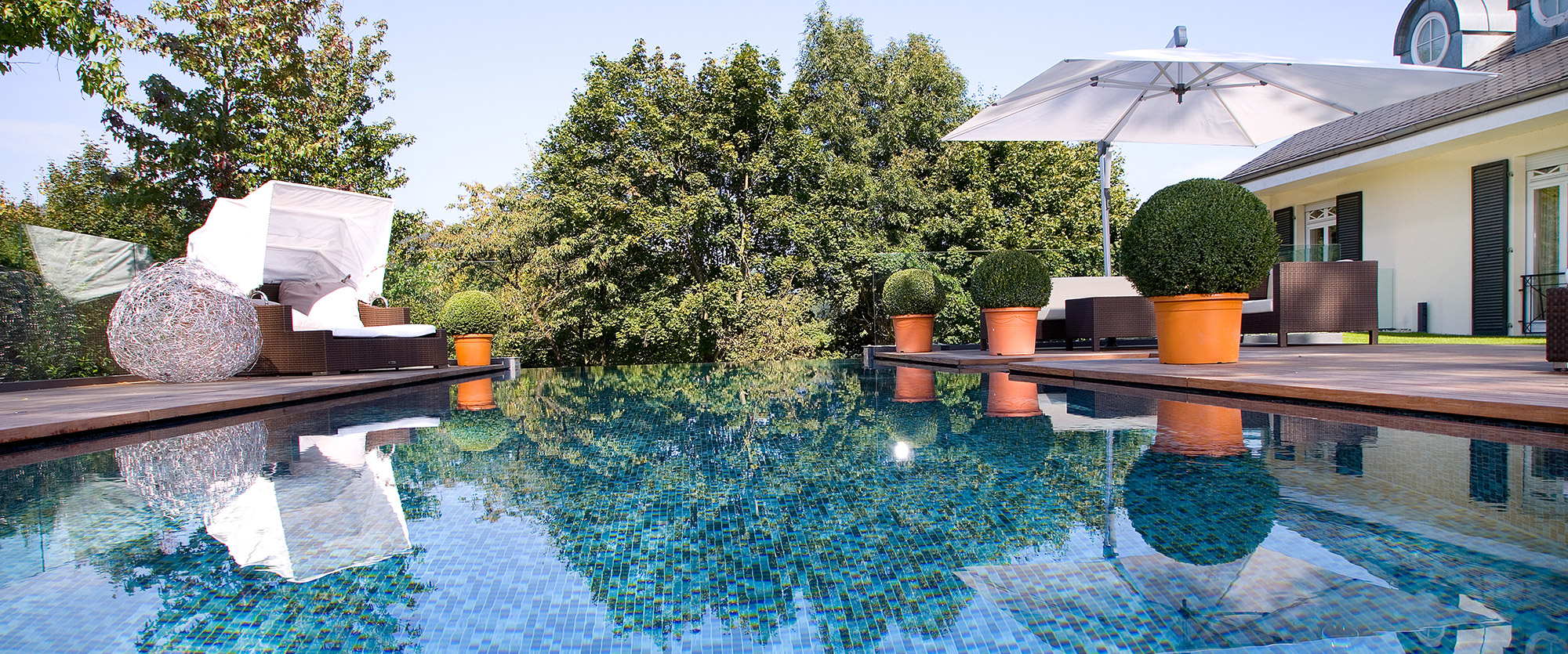 Outdoor pool with wood terrace and beach chair