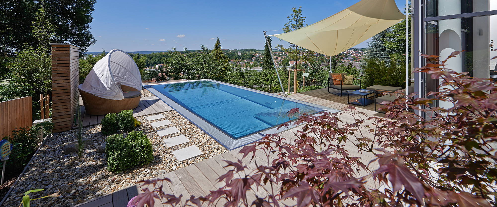 Outdoor pool with wood terrace and view